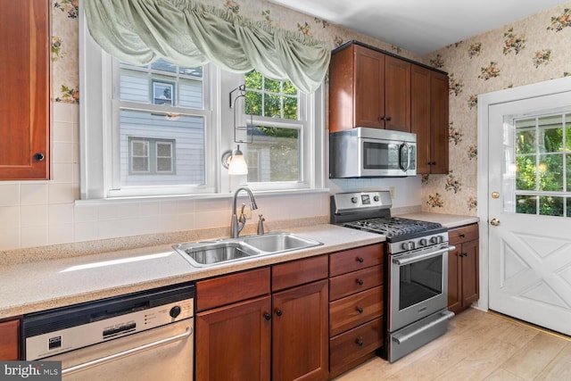 671 Edge Hill Rd, Glenside, PA 19038 - kitchen with stainless steel appliances, wallpapered walls, light countertops, backsplash, and brown cabinetry