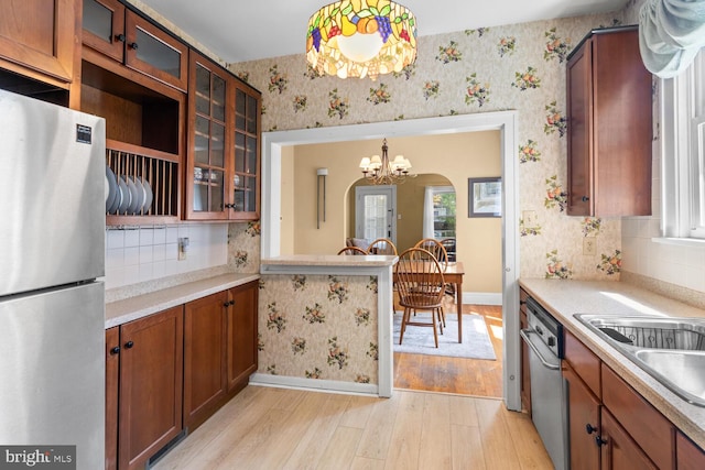 671 Edge Hill Rd, Glenside, PA 19038 - kitchen with stainless steel appliances, wallpapered walls, a chandelier, light wood-style flooring, and light countertops