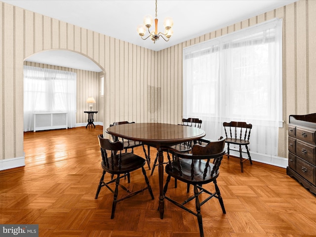 5000 Levindale Rd, Baltimore, MD 21215 - dining space featuring wallpapered walls, radiator, a chandelier, and arched walkways