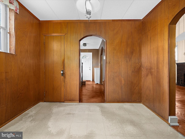 5000 Levindale Rd, Baltimore, MD 21215 - spare room featuring arched walkways, wooden walls, and tile patterned floors