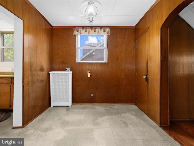 5000 Levindale Rd, Baltimore, MD 21215 - unfurnished dining area with healthy amount of natural light, wood walls, arched walkways, and radiator