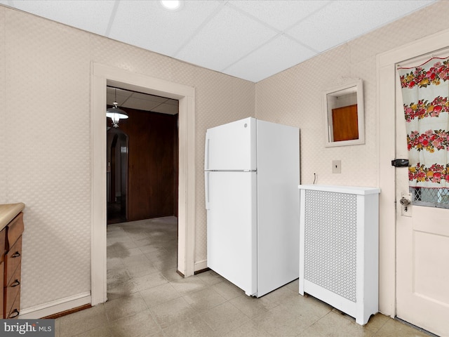 5000 Levindale Rd, Baltimore, MD 21215 - kitchen with freestanding refrigerator, wallpapered walls, and arched walkways