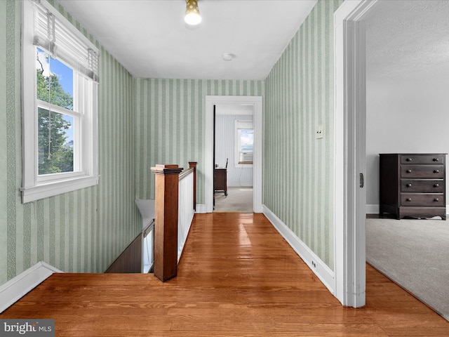 5000 Levindale Rd, Baltimore, MD 21215 - corridor with wallpapered walls, an upstairs landing, and wood finished floors