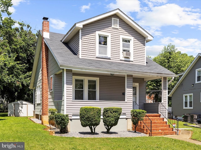 5000 Levindale Rd, Baltimore, MD 21215 - view of front facade featuring a storage unit, a porch, a front lawn, a chimney, and a shingled roof