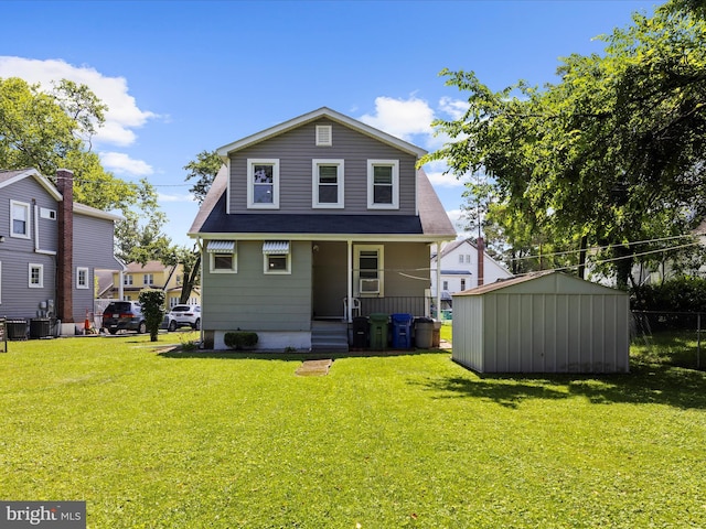 5000 Levindale Rd, Baltimore, MD 21215 - rear view of property with a storage unit, a yard, and a porch
