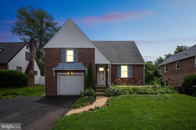 1233 E Ave, Abington, PA 19001 - view of front of property with brick siding, a front lawn, driveway, and a garage