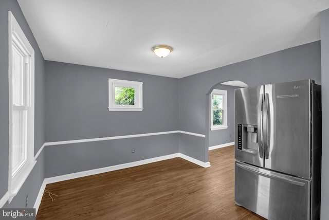 1233 E Ave, Abington, PA 19001 - kitchen featuring stainless steel fridge with ice dispenser, arched walkways, healthy amount of natural light, and wood finished floors