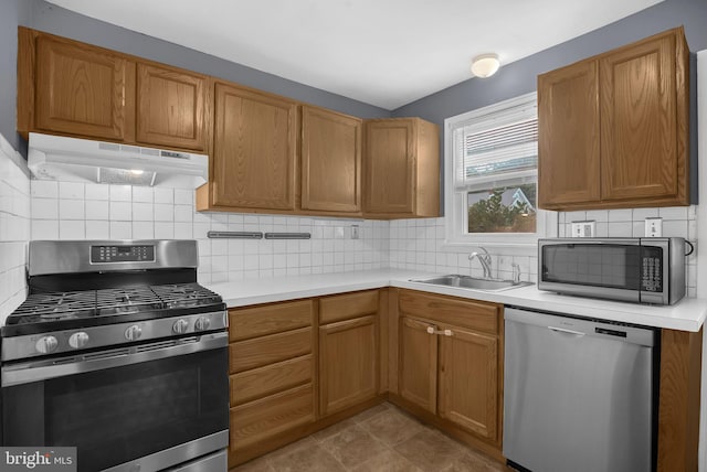1233 E Ave, Abington, PA 19001 - kitchen featuring stainless steel appliances, under cabinet range hood, light countertops, and tasteful backsplash