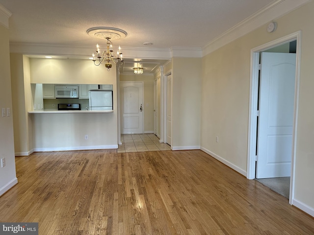 901 N Monroe St Unit 308, Arlington, VA 22201 - unfurnished living room with a chandelier, wood finished floors, and ornamental molding