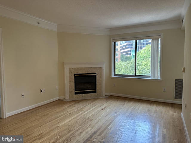 901 N Monroe St Unit 308, Arlington, VA 22201 - unfurnished living room with ornamental molding, light wood finished floors, and a high end fireplace