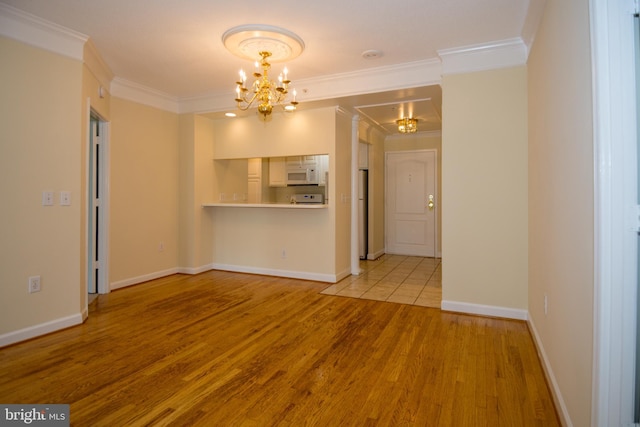 901 N Monroe St Unit 308, Arlington, VA 22201 - unfurnished living room featuring a chandelier, wood finished floors, and crown molding