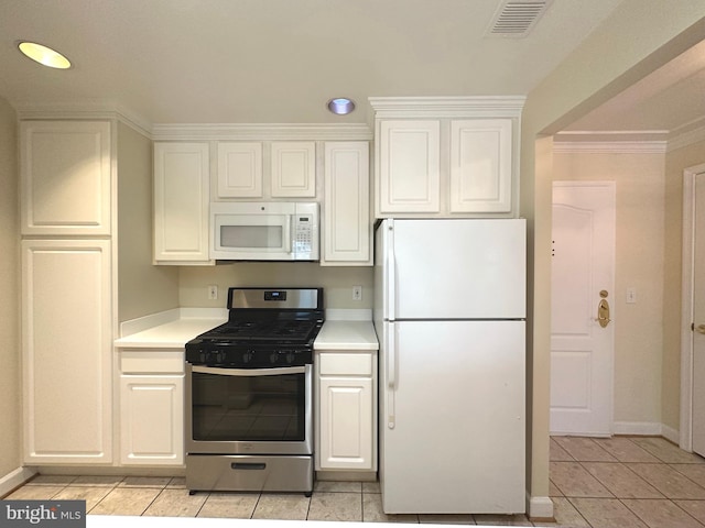 901 N Monroe St Unit 308, Arlington, VA 22201 - kitchen with white appliances, light countertops, light tile patterned flooring, white cabinetry, and ornamental molding