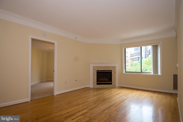 901 N Monroe St Unit 308, Arlington, VA 22201 - unfurnished living room featuring ornamental molding, a fireplace, and wood finished floors