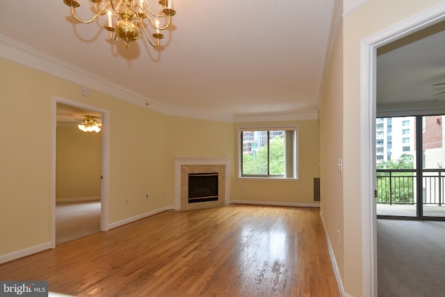 901 N Monroe St Unit 308, Arlington, VA 22201 - unfurnished living room featuring ornamental molding, wood finished floors, a chandelier, and a fireplace