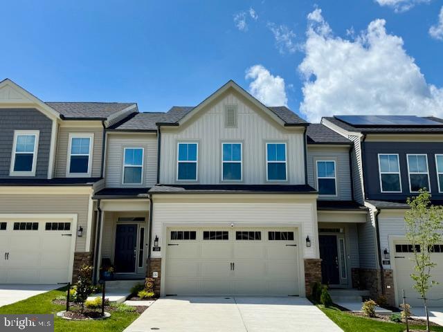 158 Bugle Way, Stafford, VA 22554 - view of front facade with a garage, driveway, board and batten siding, and stone siding