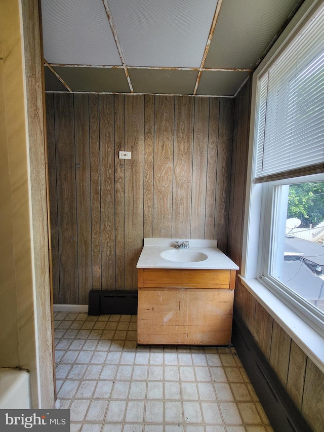 329 N 13th St, Reading, PA 19604 - bathroom featuring wooden walls, tile patterned floors, and vanity