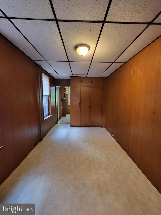 329 N 13th St, Reading, PA 19604 - spare room featuring a paneled ceiling, light flooring, and wood walls