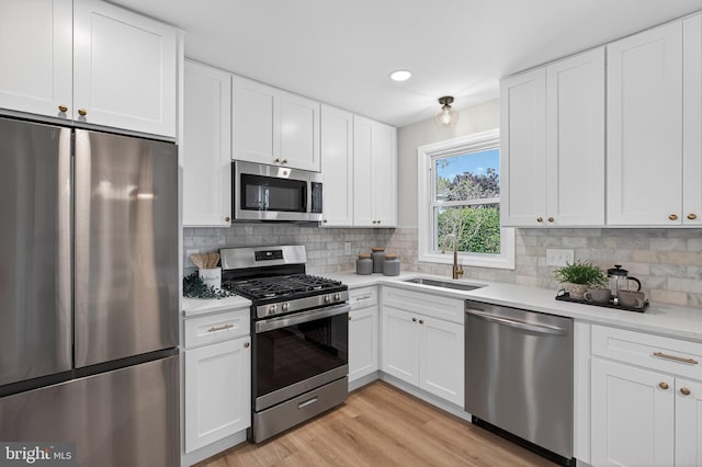 3803 Kayson St, Silver Spring, MD 20906 - kitchen featuring appliances with stainless steel finishes, light countertops, backsplash, white cabinetry, and recessed lighting