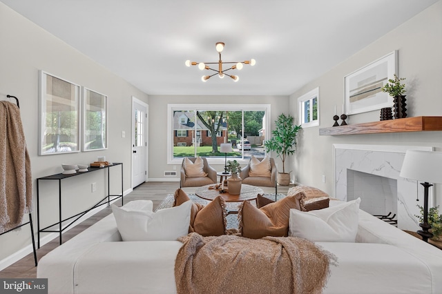 3803 Kayson St, Silver Spring, MD 20906 - living area featuring a premium fireplace, light wood finished floors, and a chandelier