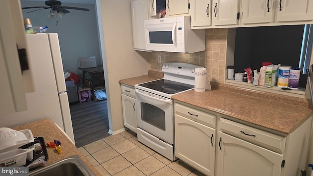 2622 Cranberry Cir, Harrisburg, PA 17110 - kitchen with white appliances, a ceiling fan, backsplash, light tile patterned flooring, and white cabinetry