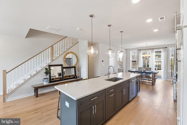 324 Star Tavern Ln, West Chester, PA 19382 - kitchen with light wood-type flooring, an island with sink, dishwasher, a chandelier, and hanging light fixtures