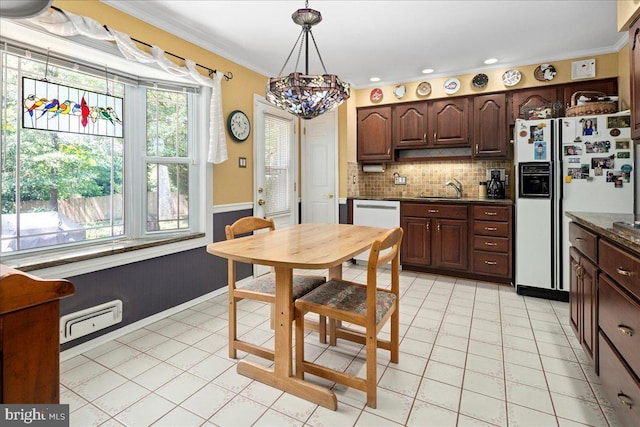 9210 Cherrytree Dr, Alexandria, VA 22309 - kitchen with white appliances, plenty of natural light, dark countertops, ornamental molding, and wainscoting