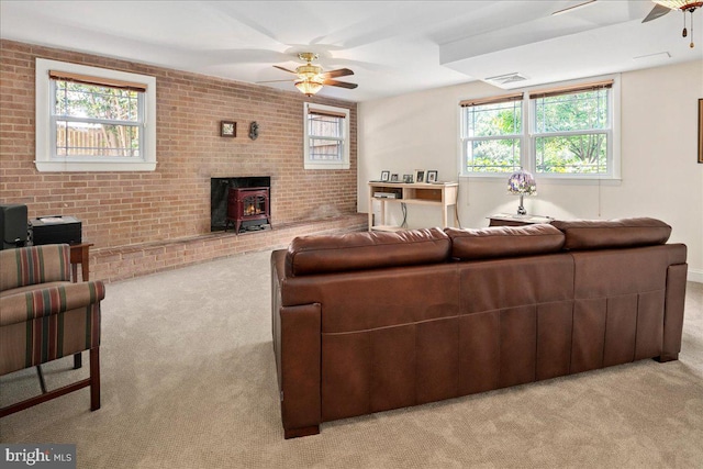 9210 Cherrytree Dr, Alexandria, VA 22309 - living area with ceiling fan, light colored carpet, a wood stove, plenty of natural light, and brick wall