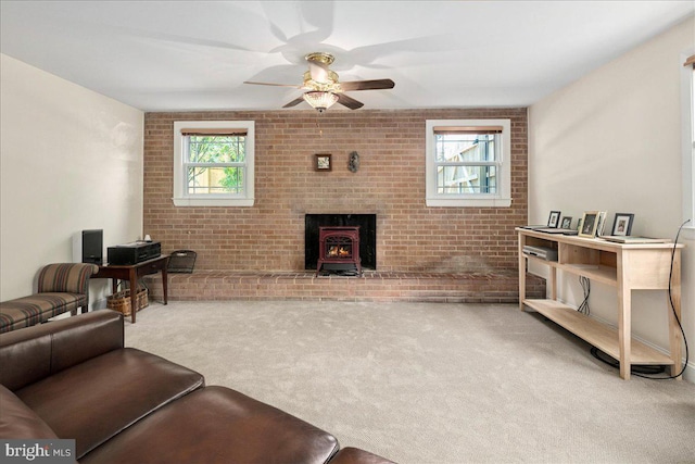 9210 Cherrytree Dr, Alexandria, VA 22309 - living area featuring carpet flooring, brick wall, ceiling fan, and a wood stove