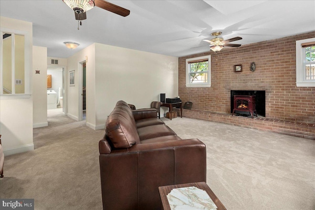 9210 Cherrytree Dr, Alexandria, VA 22309 - carpeted living area with ceiling fan, a wood stove, and washer / dryer