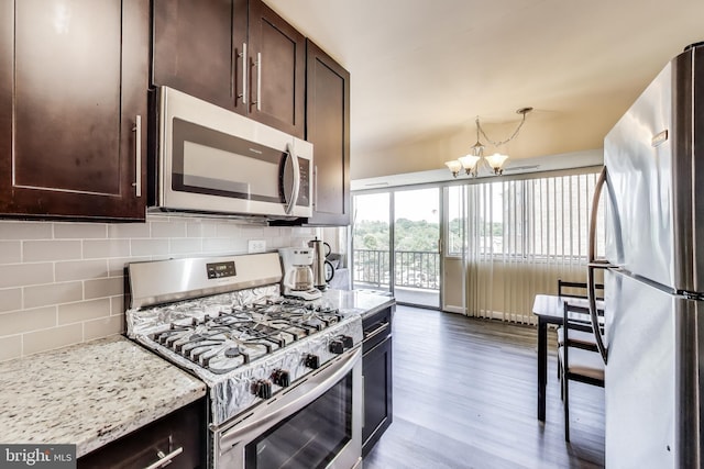 5851 Quantrell Ave Unit 407, Alexandria, VA 22312 - kitchen with appliances with stainless steel finishes, dark brown cabinets, a chandelier, and dark wood finished floors