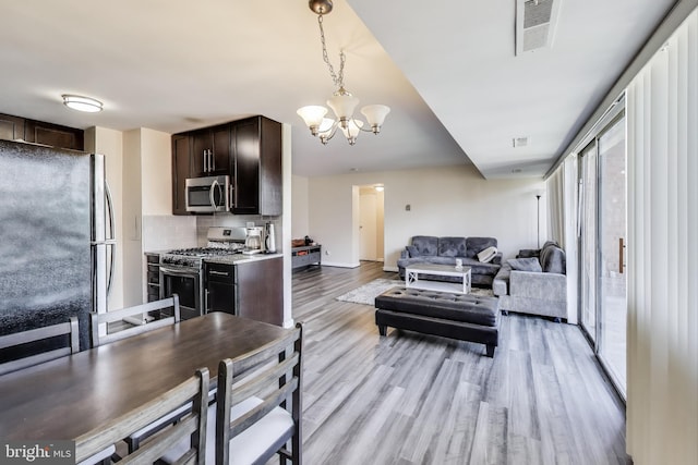 5851 Quantrell Ave Unit 407, Alexandria, VA 22312 - living room with a chandelier and light wood-style floors