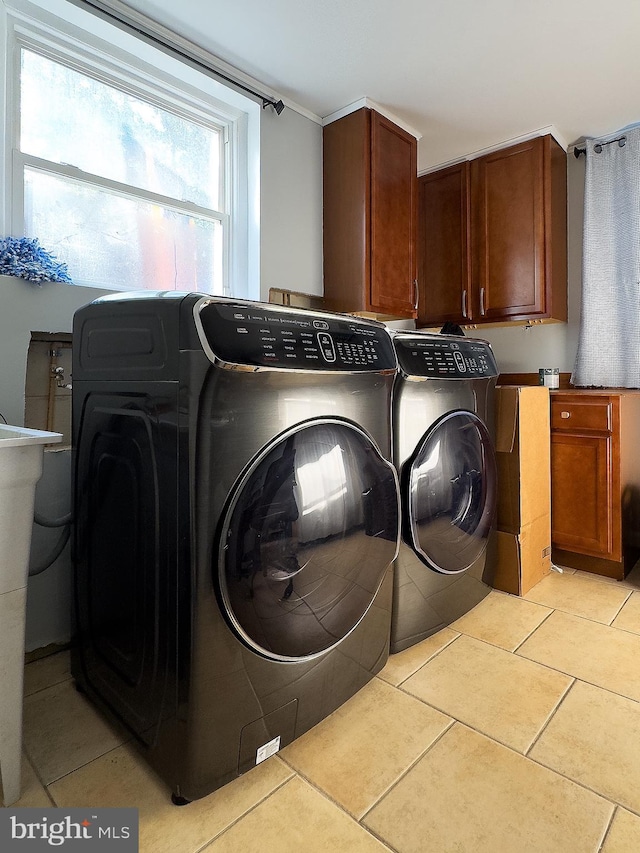 6802 Temple Hill Rd, Temple Hills, MD 20748 - laundry room featuring separate washer and dryer, cabinet space, and light tile patterned floors