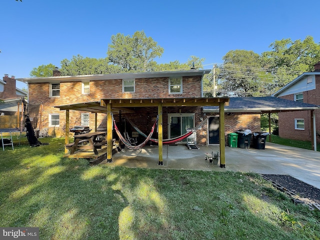 6802 Temple Hill Rd, Temple Hills, MD 20748 - back of house with a patio, a yard, brick siding, concrete driveway, and an attached carport