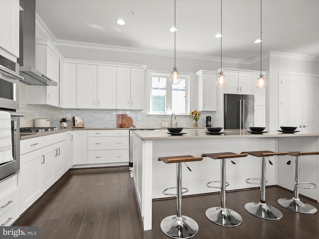 11412 Dairy St, Fulton, MD 20759 - kitchen with stainless steel appliances, crown molding, a breakfast bar, wall chimney range hood, and dark wood-style floors
