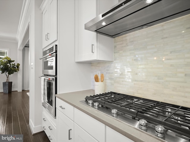 11412 Dairy St, Fulton, MD 20759 - kitchen with premium range hood, appliances with stainless steel finishes, crown molding, backsplash, and white cabinets