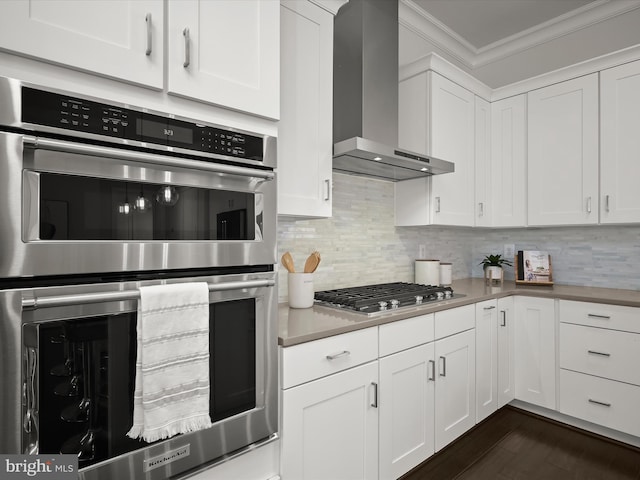 11412 Dairy St, Fulton, MD 20759 - kitchen with stainless steel appliances, wall chimney exhaust hood, crown molding, light countertops, and white cabinetry