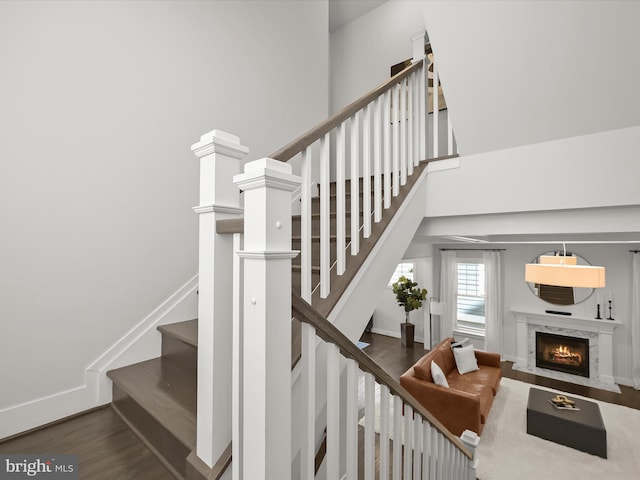 11412 Dairy St, Fulton, MD 20759 - stairs featuring a fireplace, wood finished floors, and a high ceiling