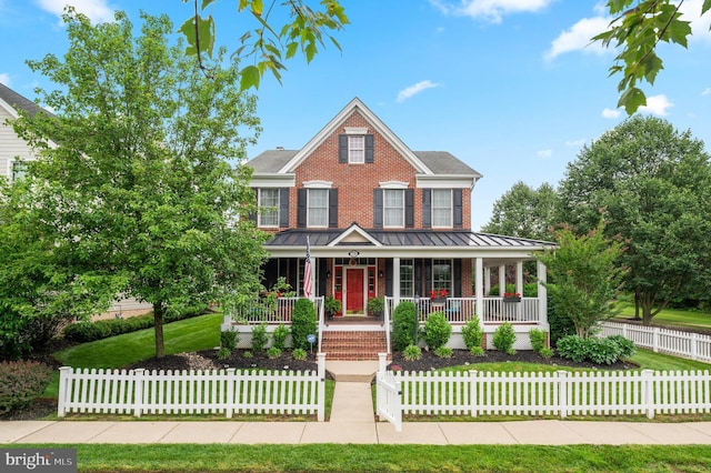 236 Cambridge Pl, Chalfont, PA 18914 - view of front facade featuring covered porch, brick siding, a fenced front yard, and a standing seam roof