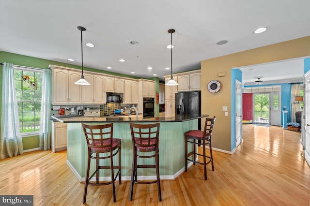 236 Cambridge Pl, Chalfont, PA 18914 - kitchen with black appliances, backsplash, light wood finished floors, dark countertops, and a kitchen breakfast bar