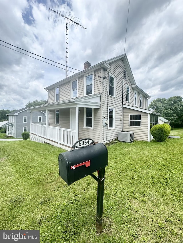 6054 Baltimore Pike, Littlestown, PA 17340 - view of front of house featuring covered porch, a front lawn, and a chimney