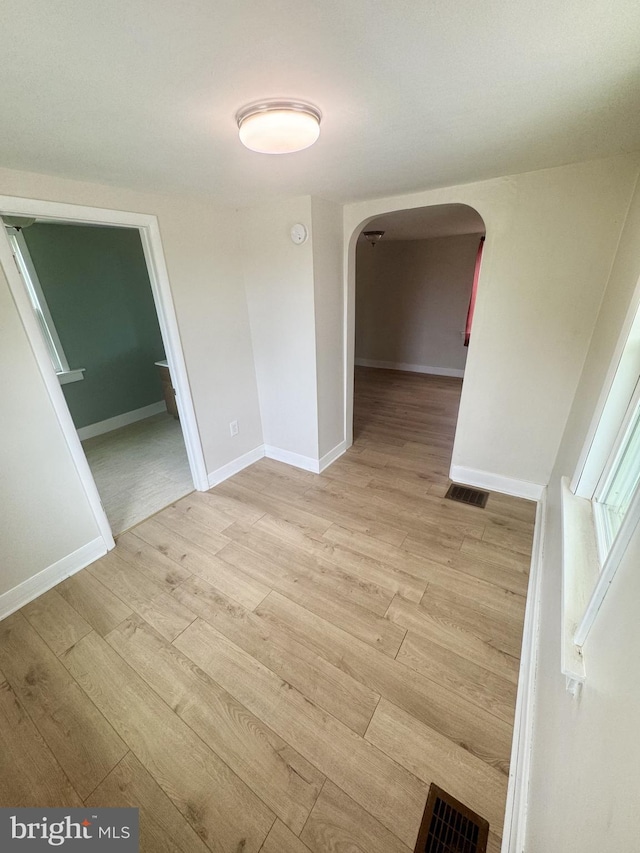 6054 Baltimore Pike, Littlestown, PA 17340 - unfurnished room featuring arched walkways, light wood-style flooring, and a smoke detector