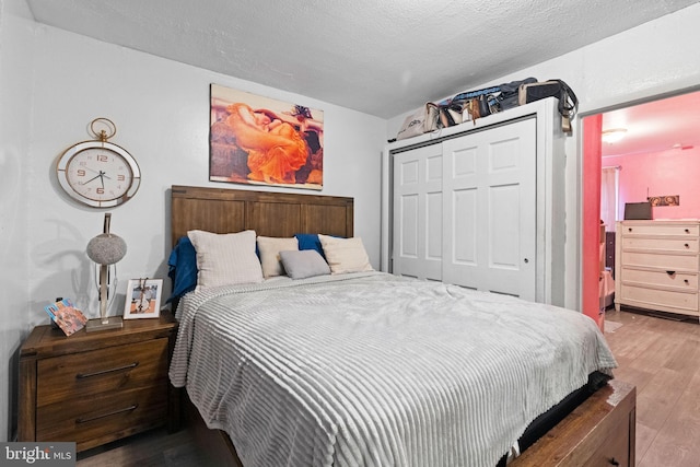 330 N 13th St, Reading, PA 19604 - bedroom featuring wood finished floors, a closet, and a textured ceiling