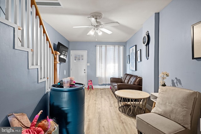 330 N 13th St, Reading, PA 19604 - living room featuring wood finished floors, a ceiling fan, and stairs