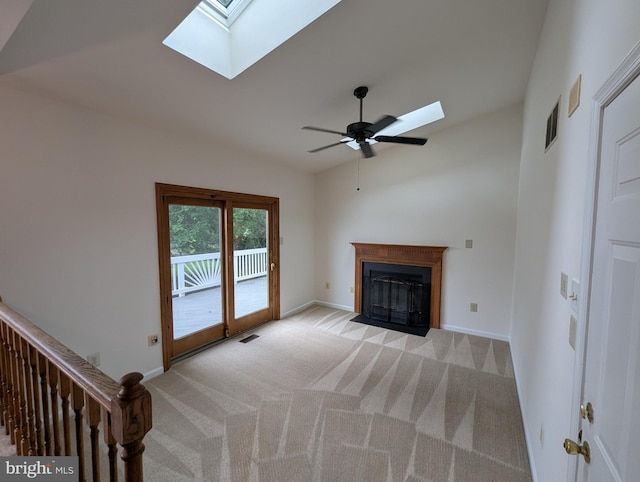 332 Hill Ct, Havre De Grace, MD 21078 - unfurnished living room with a skylight, carpet flooring, a fireplace with flush hearth, a ceiling fan, and lofted ceiling