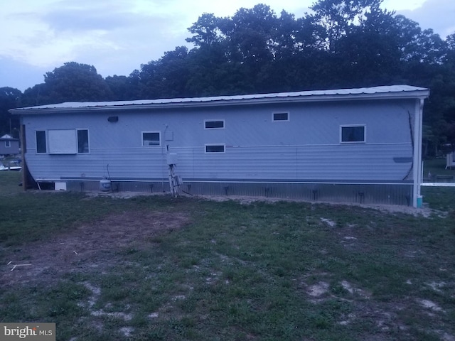 30768 W Lagoon Rd, Dagsboro, DE 19939 - rear view of house with a lawn and a metal roof