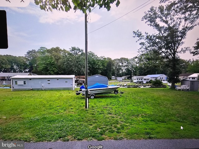 30768 W Lagoon Rd, Dagsboro, DE 19939 - view of yard featuring a storage unit and view of wooded area