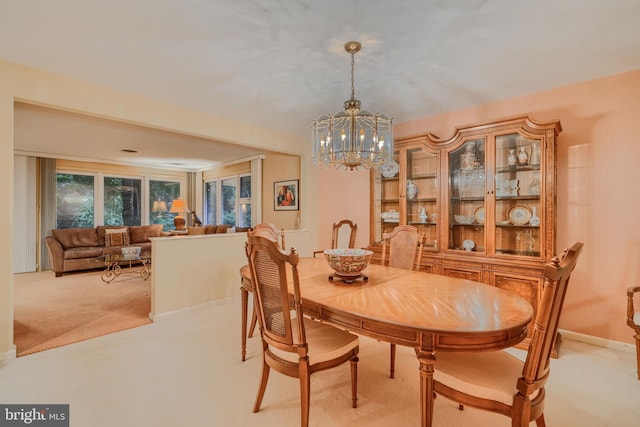 7900 Ivy Ln, Baltimore, MD 21208 - dining area featuring a chandelier and light carpet