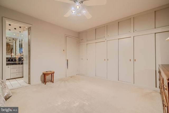 7900 Ivy Ln, Baltimore, MD 21208 - unfurnished bedroom with light colored carpet, ensuite bathroom, ceiling fan, and two closets
