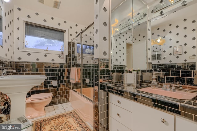 7900 Ivy Ln, Baltimore, MD 21208 - bathroom featuring shower / bath combination with glass door, vanity, tile patterned floors, tile walls, and wallpapered walls