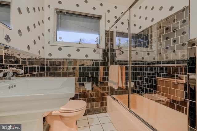 7900 Ivy Ln, Baltimore, MD 21208 - full bathroom with bath / shower combo with glass door, tile patterned flooring, tile walls, and wallpapered walls